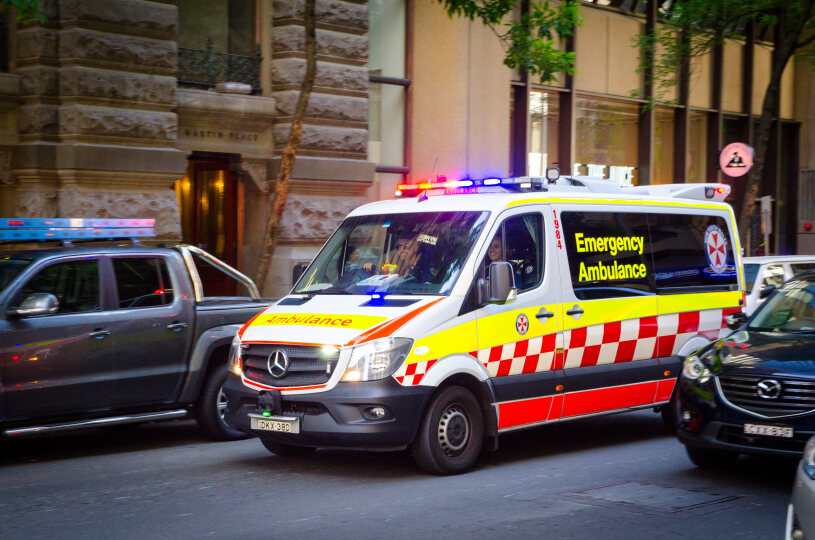 Ambulance driving along street.